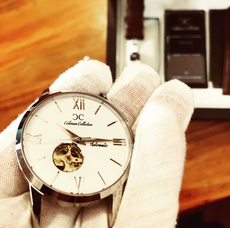 Coleman Collection white dial held with inspection gloves